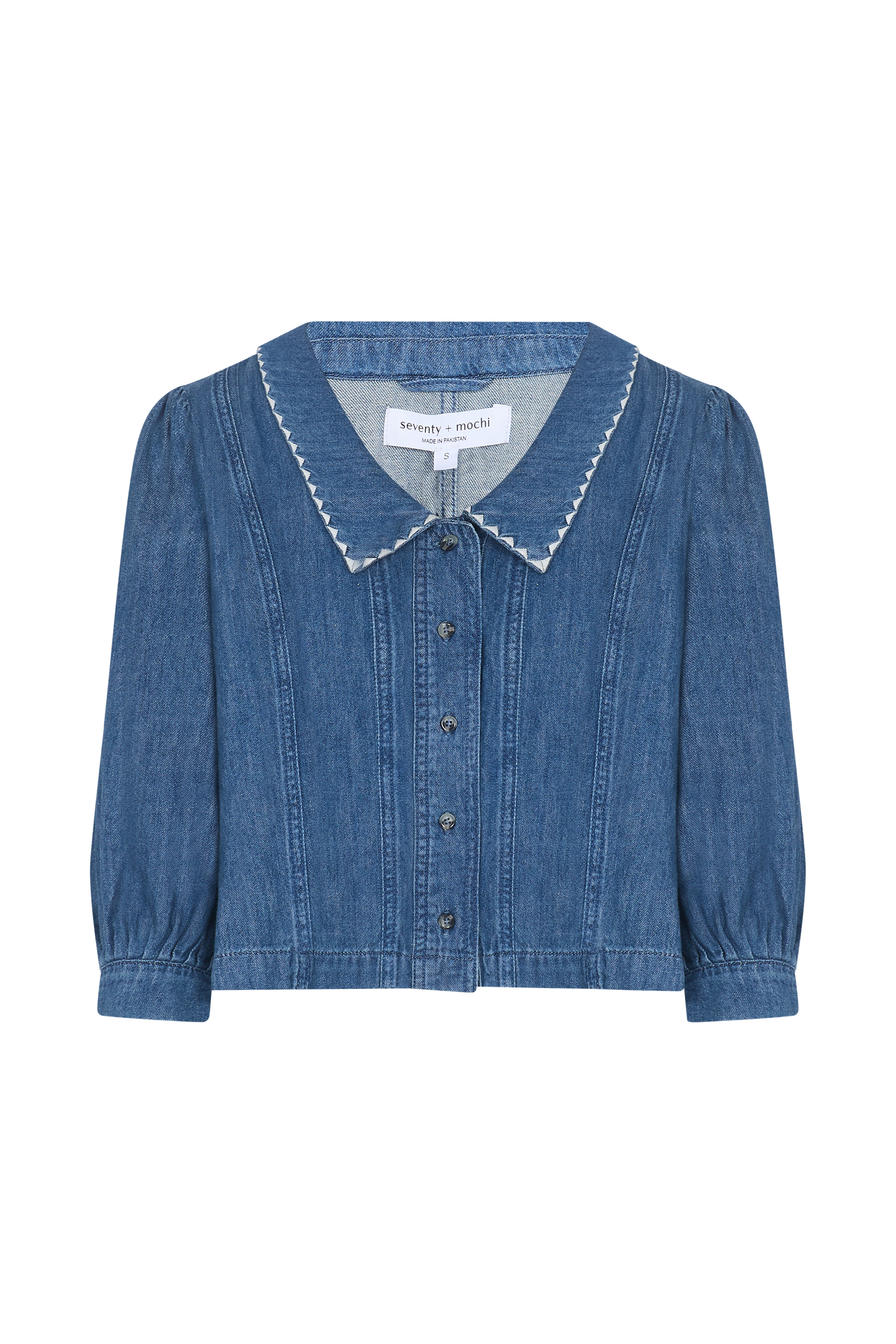 Blue denim button up top with an oversized collar on a white background